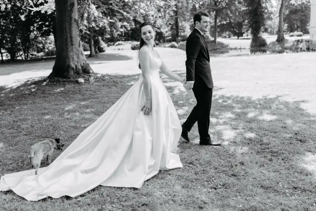 Hochzeitspaar Hand in Hand laufen auf Gut Kletkamp